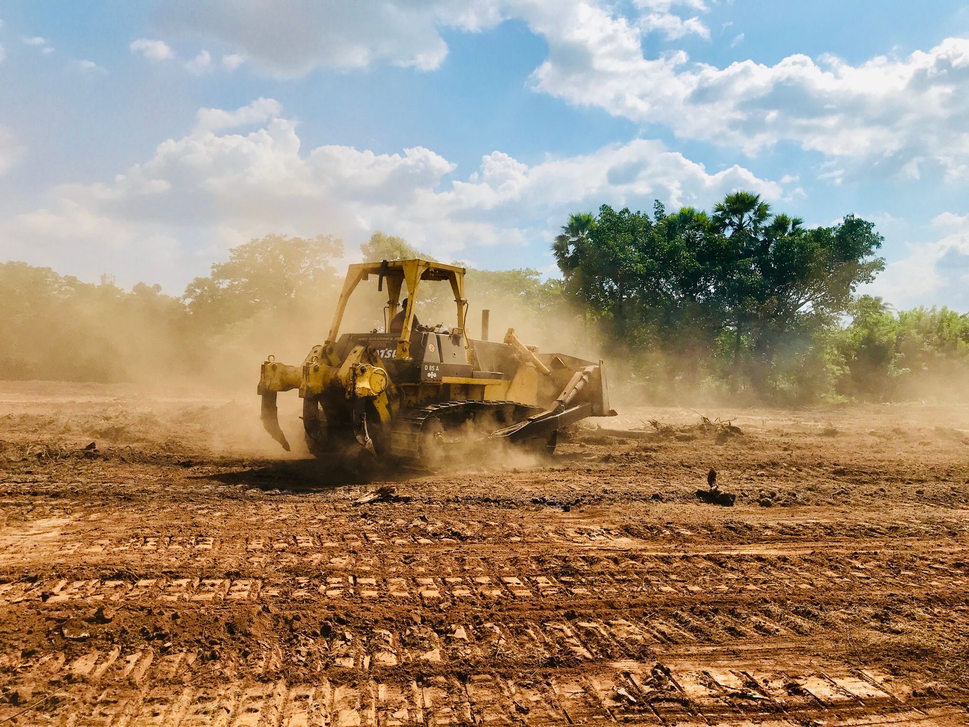 Land clearing equipment working at dusk